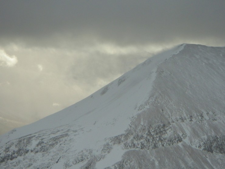 Spindrift blowing 100's of metres out off the summits ahead of a shower.