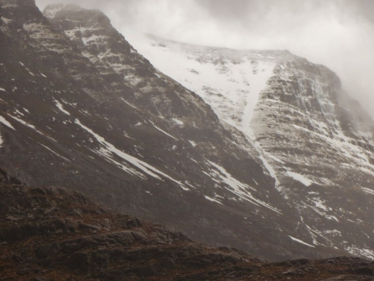 A grim view of Liathach, with the snow level rising in the mild temperatures.