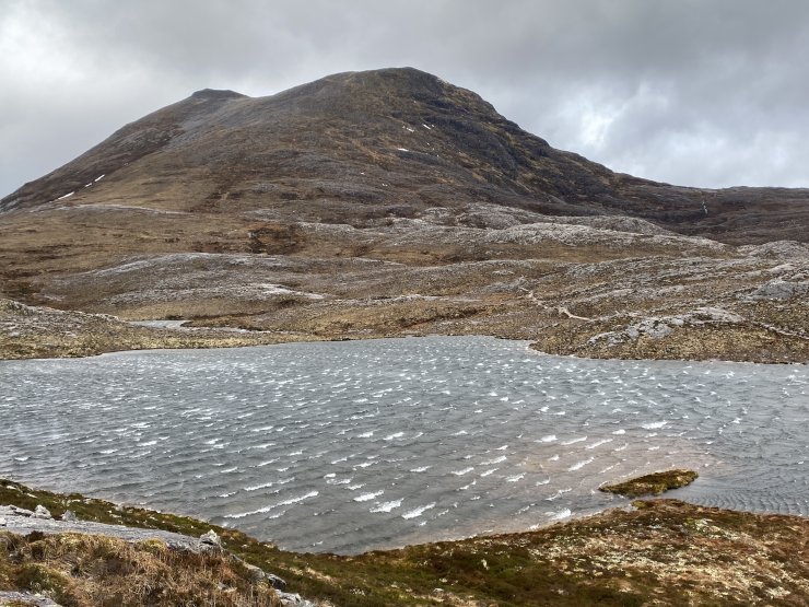 Meall Ghiuthais across a storm tossed lochan.