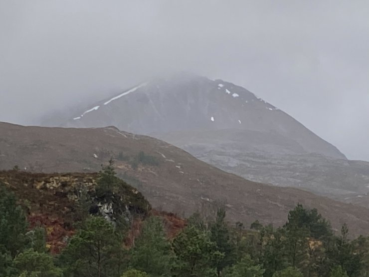 Creag Dubh in the mist, showing only streaks of snow around the Coire Rim.