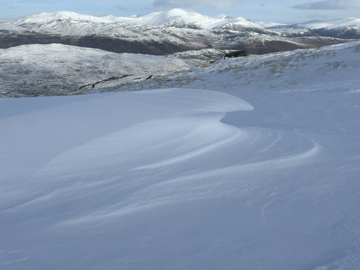 Wind sculpted snow, showing erosion, and snow transport.